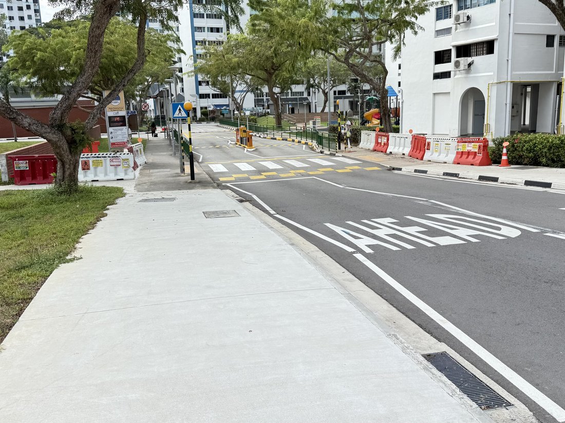 The 'AHEAD' road marking painted on the approach to the zebra crossing