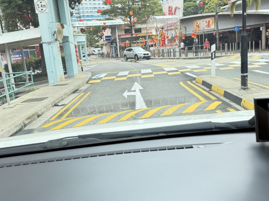A residential road with humps positioned a few metres before a raised crossing